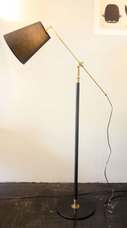 Black painted metal and brass floor light designed by Kaare Klint for makers Le Klint. The arm is fitted on a ball joint making the light super flexible.