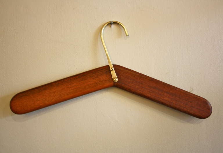 Walnut hanger with brass fittings by Carl Aubock. Great colour to the wood and beautifully made to the core.