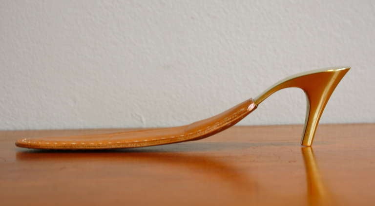 Great sculptural showhorn in cast brass with a leather slip. Made by the Aubock workshop in the 1950s.