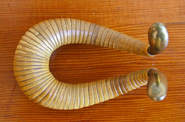 Brass and cane pipe holder designed by Carl Aubock and made by his workshop in the 1950s. As much a sculpture as a functional piece with original wicker in perfect condition.