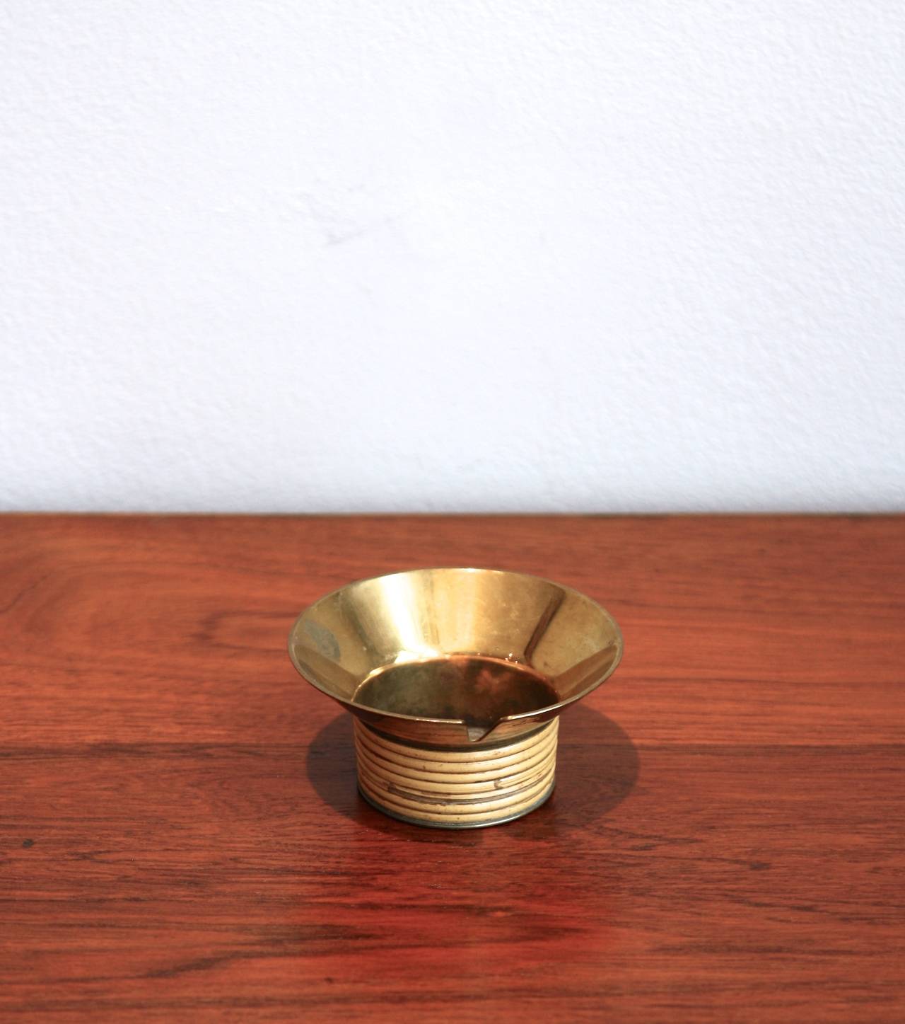 Lovely brass and original wicker ashtray by the famous workshop of Carl Auböck.