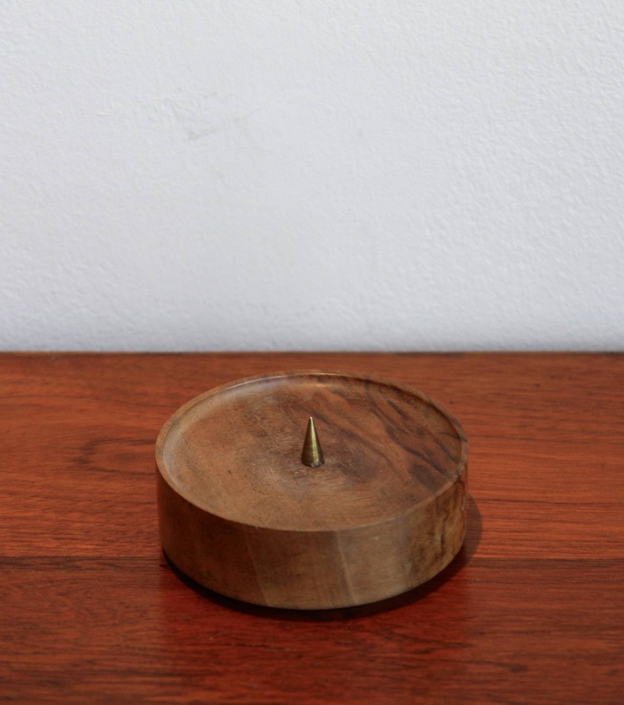 Lovely wood and brass candleholder by Carl Auböck. Walnut base and brass spike.