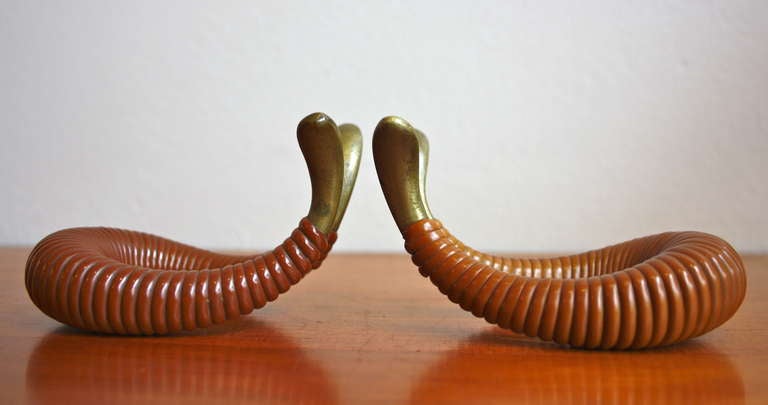 Pair of brass sculptural pipe holders covered in a synthetic material. Original covering in excellent condition. 