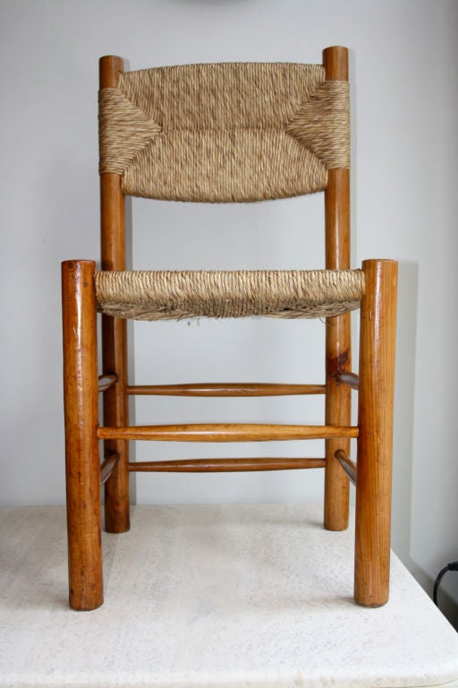 Pair of original Charlotte Perriand sidechairs. Elegant design and execution of the traditional French farm chair , the French version of Gio Ponti's Superleggera which was based on the classic Italian farm chair. Beautiful patina to the wood and