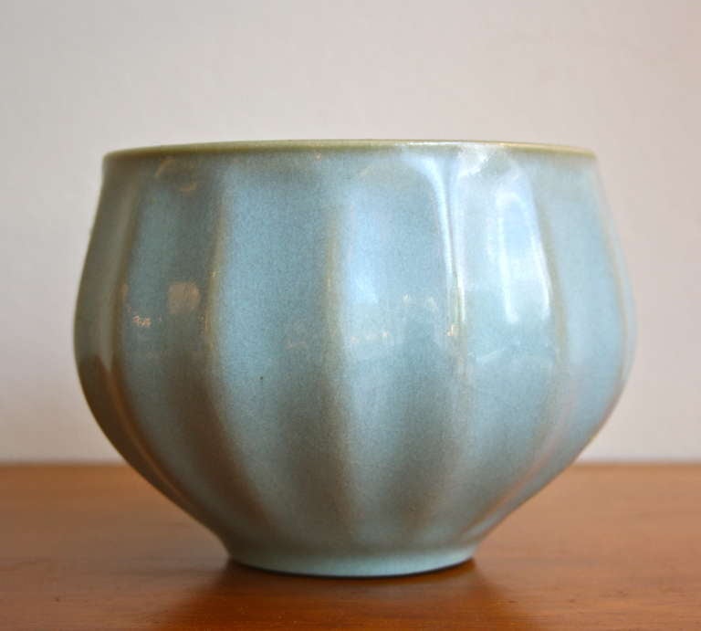 Beautiful bowl designed by artist Eva Staehr Nielsen in a blue glaze. Made by Royal Copenhagen in a hardpaste body with a semi revealing blue glaze. Eva Staehr Nielsen is more commonly know as the artist behind the shapes of 1940s ceramics studio