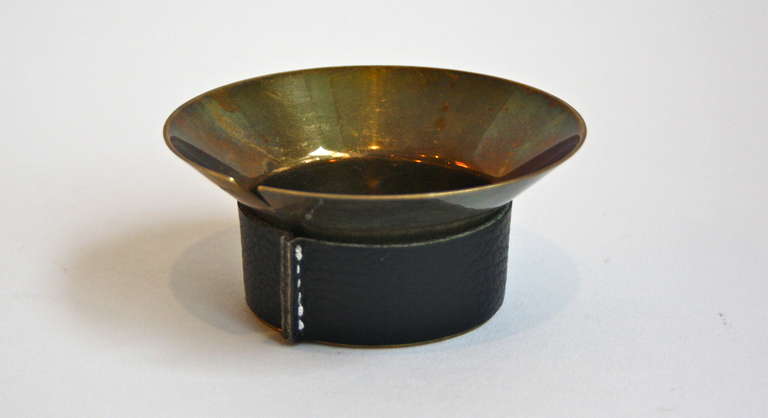 Great elegant brass ashtray with a leather trim. Clearly showing the artistic origin of all the Aubock shapes.