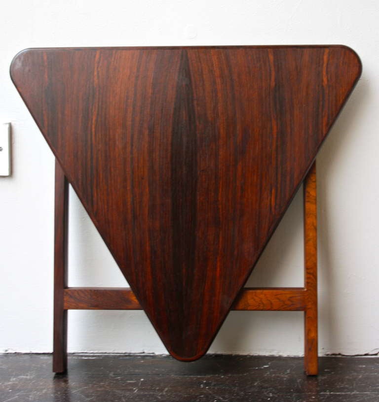 Great small triangular folding table made in Rio Rosewood by CFC Silkeborg. Looks great folding and in use.
