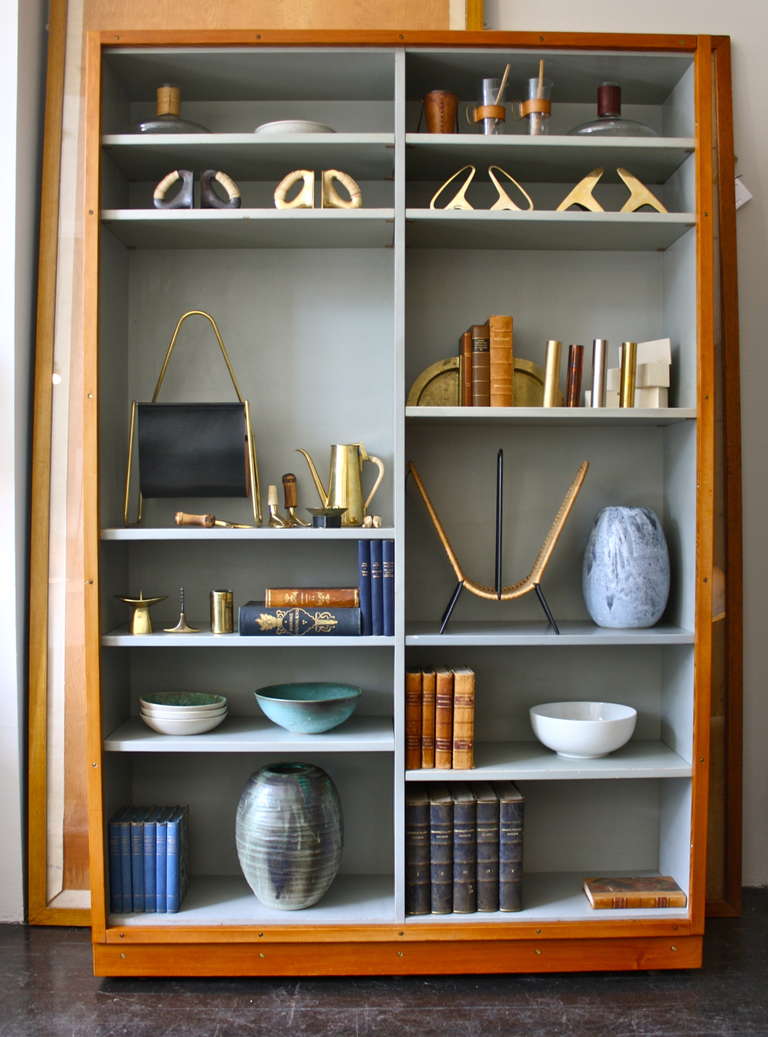 We have a large collection of these classic bookcases know as Boligens Byggeskabe , created by Boerge Mogensen and Grete Meyer. Grey painted frame with an oregon pine front and base.