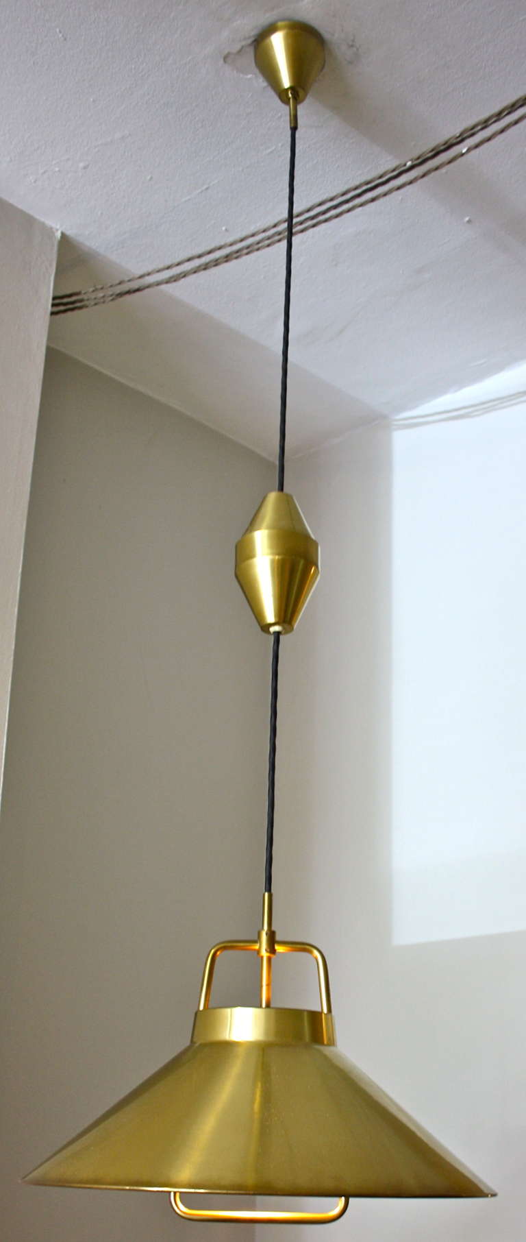 Great rise and fall brass pendant light by Frits Schegel. Schegel worked for Wilhelm Lauritzen and is thought to be the designer behind some of the fantastic lights emerging from the studio in the 1940s