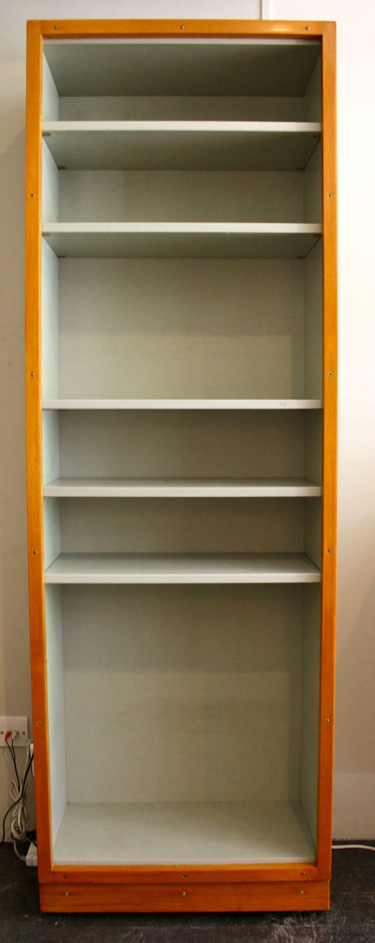 We have a large collection of these classic bookcases know as Boligens Byggeskabe , created by Boerge Mogensen and Grete Meyer. Grey painted frame with an oregon pine front and base.