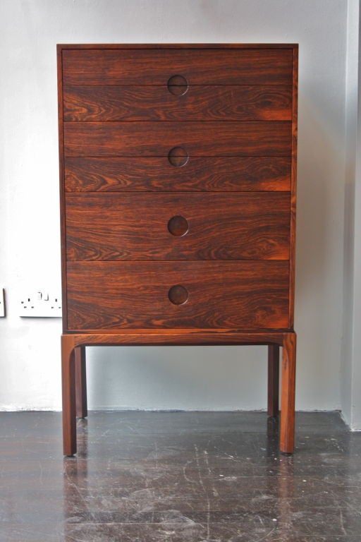 Rare tall chest of drawers by cabinetmaker Axel Kjaersgaard. Made in Denmark in the 1950s in Rio Rosewood with his trademark circular handles