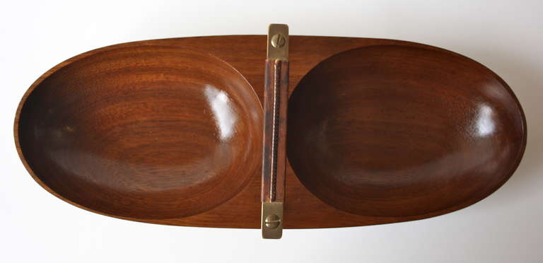 Great double serving bowl by Carl Auböck in carved Walnut , brass and leather.