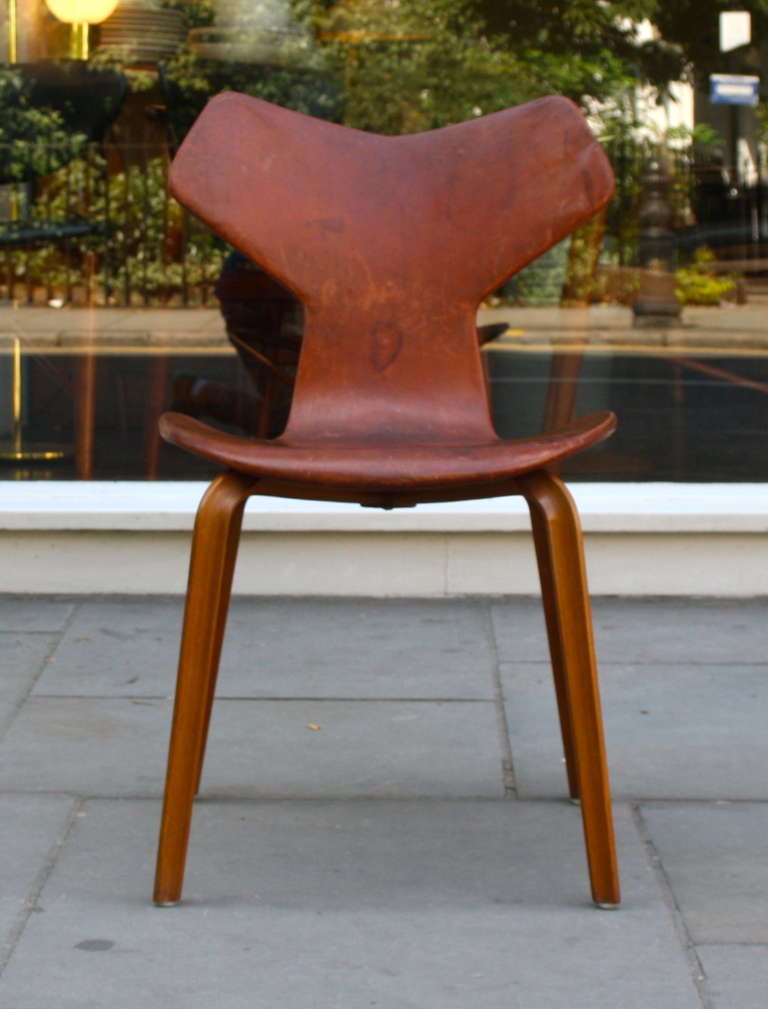 This amazing chair was designed in 1957 and the same year awarded the highest award (Grand Prix) at Triennale in Milan. This particular chair has a wonderful cognac Leather, built up over years of use. An amazing piece for anyone's collection.