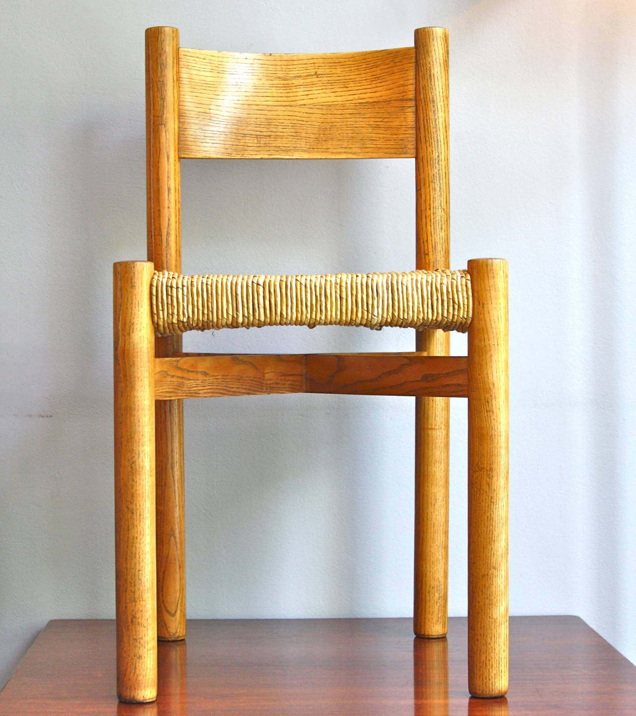 A strong and beautiful side chair by Charlotte Perriand. Taking inspiration from classic french framer furniture and seating this wonderful piece is executed perfectly. With an amazing hand woven rush seat and amazing proportions applied to the