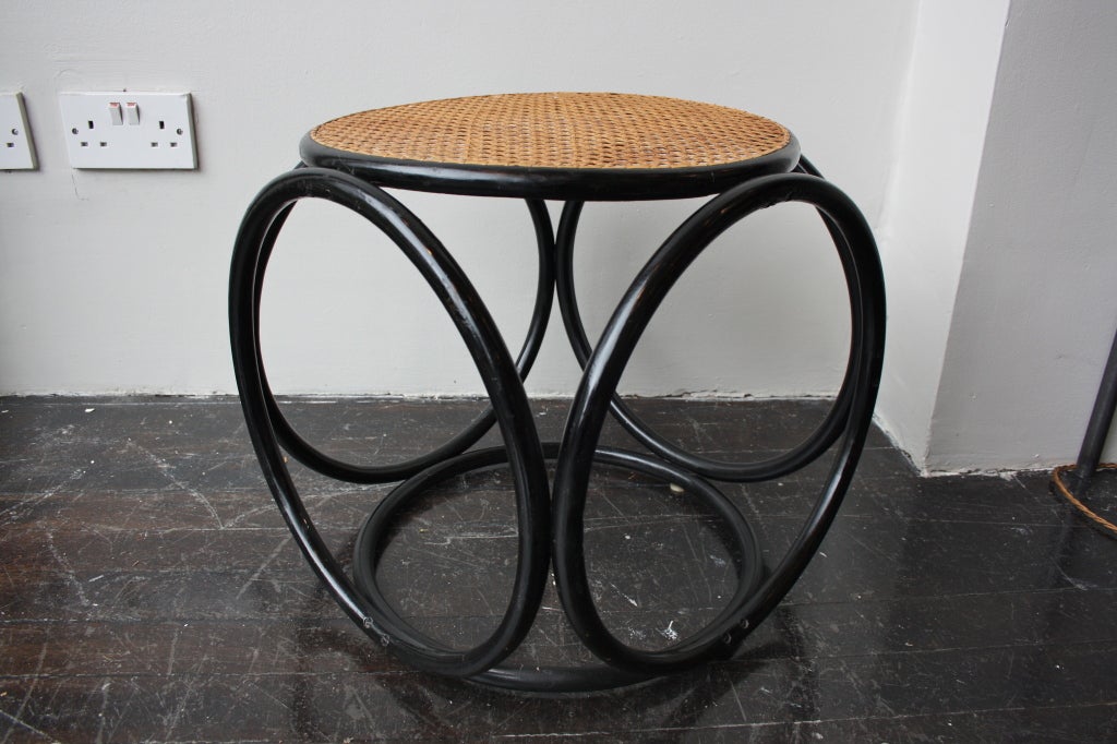 Early stool designed by Michael Thonet for Gebruder Thonet c. 1910. Handwoven cane and black stained frame.  Handwoven cane which has properly been replaced at some point in the life of the stool but a long time ago.