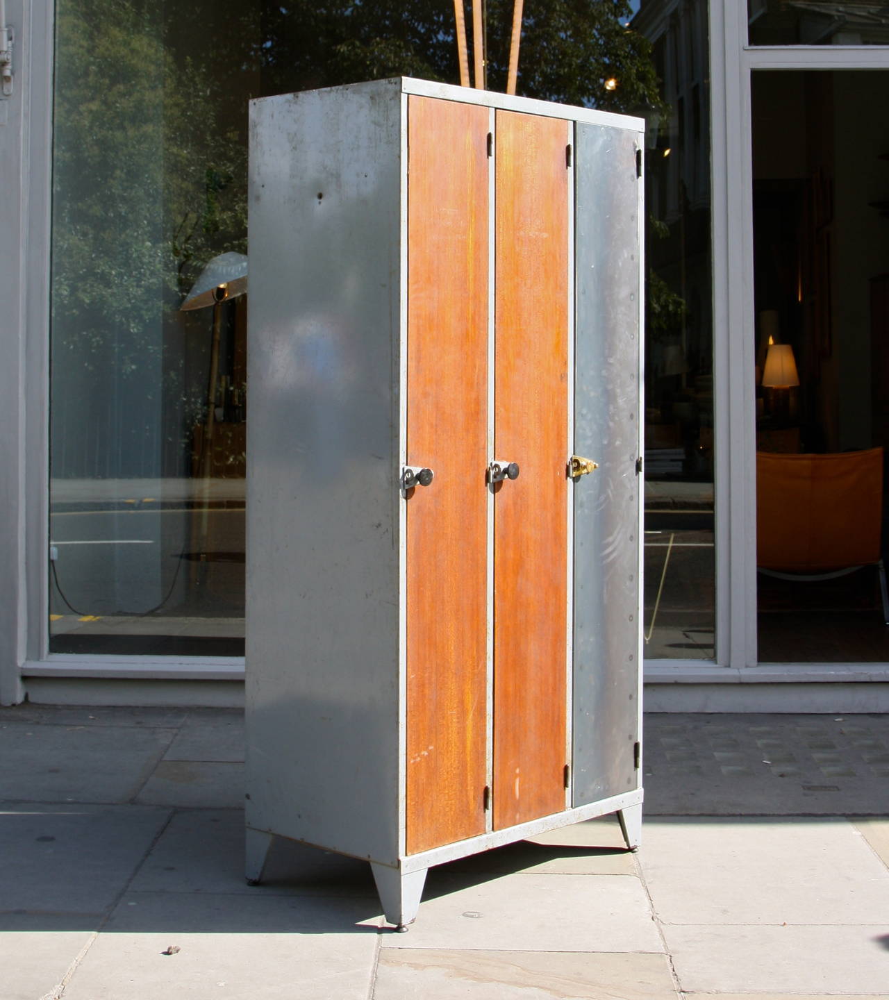 Vintage large locker with two doors in beautiful textured teak and one in dark grey metal. 
The structure is in lighter painted metal and one handle and one foot in brass.