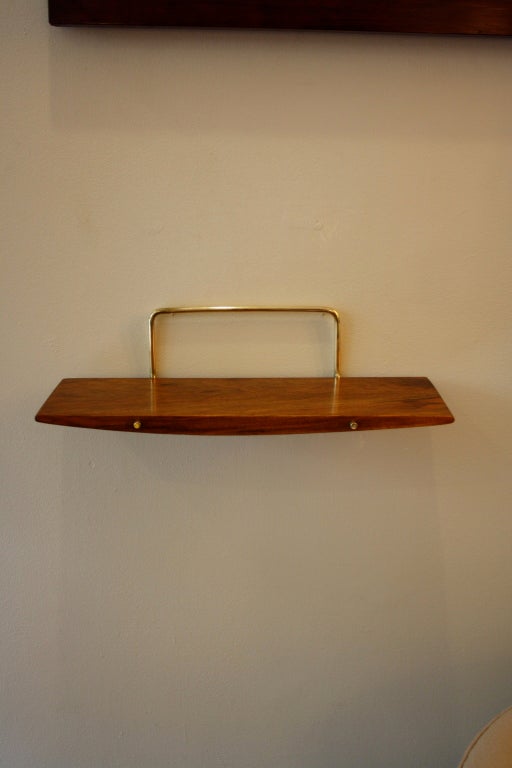 Brass and walnut shelf designed by Carl Aubock and made by his workshop. Great colour to the aged walnut.