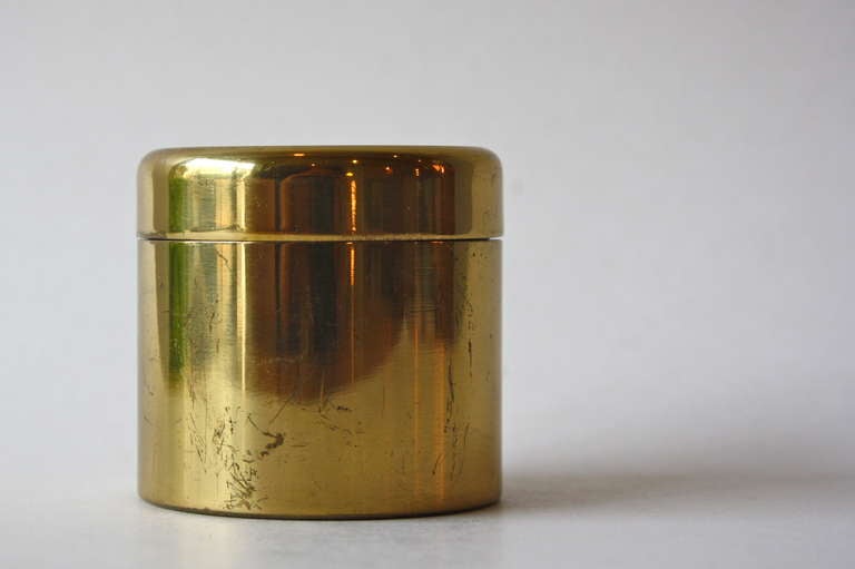 Elegant little brass container with a magnifying glass in the lid.