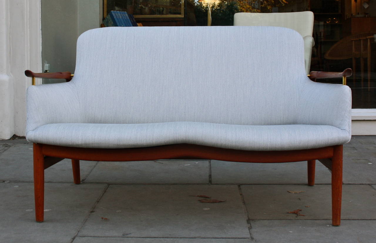 Teak sofa designed by Finn Juhl and made by master cabinetmaker Niels Vodder. Great sculptural arms making it unmistakably Finn Juhl. A classic marriage of Finn Juhl's sculptural aesthetics with the superb skills of Niels Vodder.