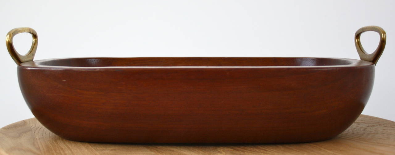 A strong recessed tray, hand-carved in teak with cast brass handles by Carl Auböck. The teak has lovely rich color and smooth finish. The handles are beautifully cast with the Auböck stamp on the side of one. An honest object from honest beginnings.