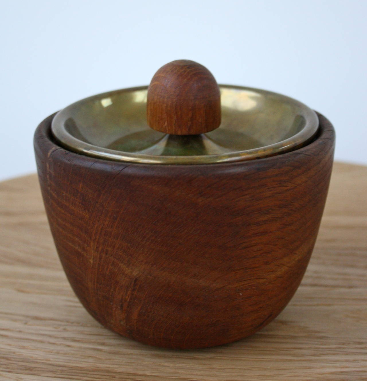Beautifully turned walnut bowl with an accompanying brass lid with a leather seal. Used for tobacco, hints of the rich smell still are present. With exquisite leather work and hand working of brass, this Viennese 1950s pot would make a wonderful