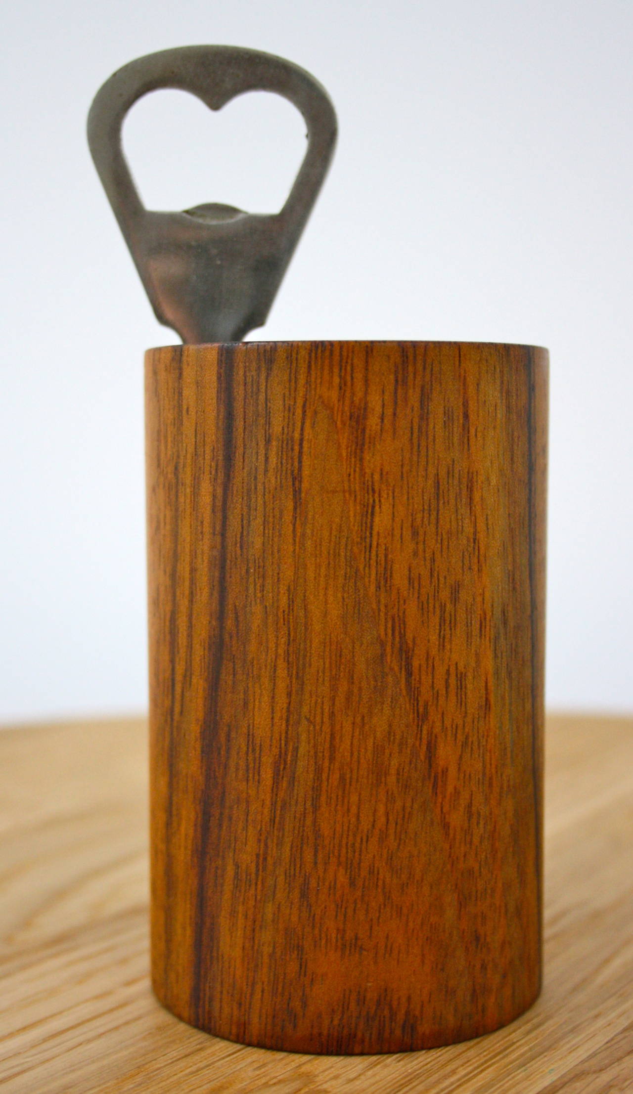 Solid walnut holder and steel bottle opener by Carl Auböck. Made in the Vienna workshop is has quality and humour and only gets better with time.