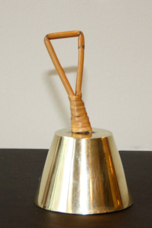 Heavy brass bell with a wicker handle by Carl Aubock. In great condition.