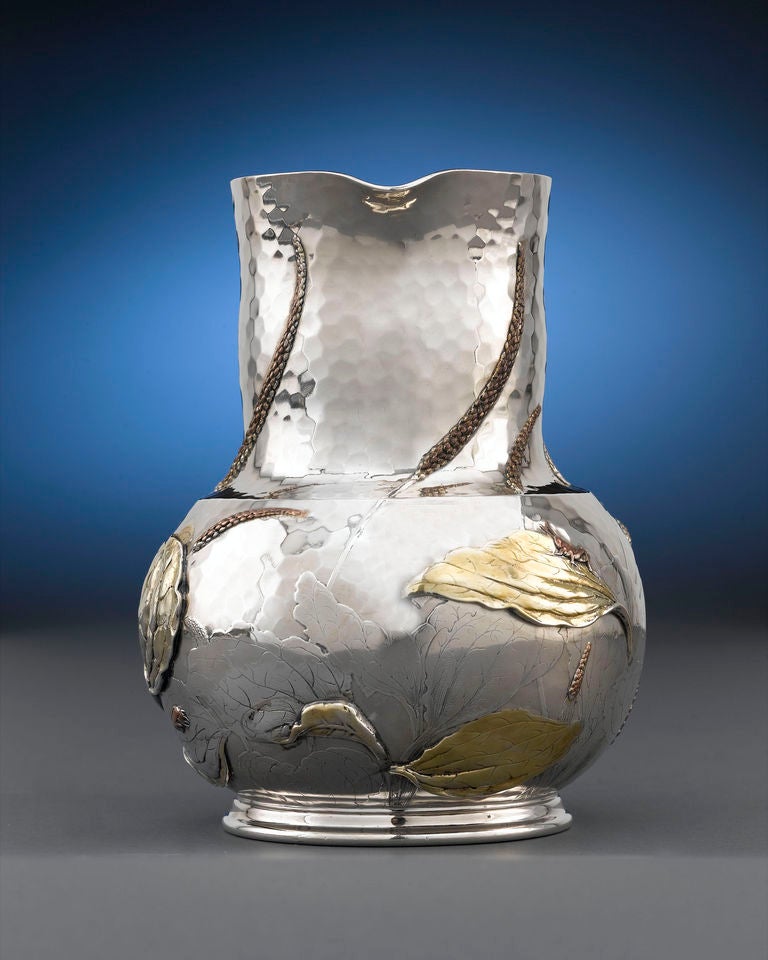 This splendid sterling silver water pitcher by Tiffany & Co., crafted in the extraordinary Japanese style, exhibits the distinguishing hand-hammered finish and applied naturalistic decorations for which this incredible pattern garnered so much