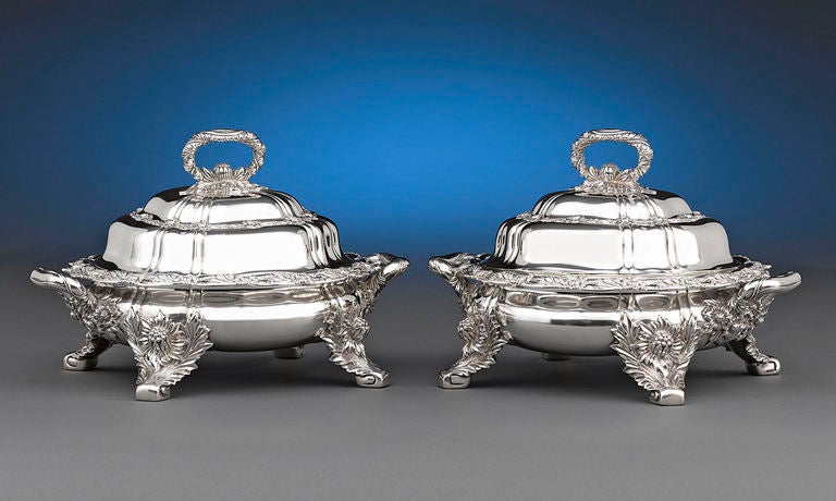 This outstanding pair of Tiffany & Co. sterling silver entrée dishes displays the popular and distinctive Chrysanthemum pattern. This exuberant motif’s signature flowers grace the antique dishes from the looped handled to the charming scrolled feet.
