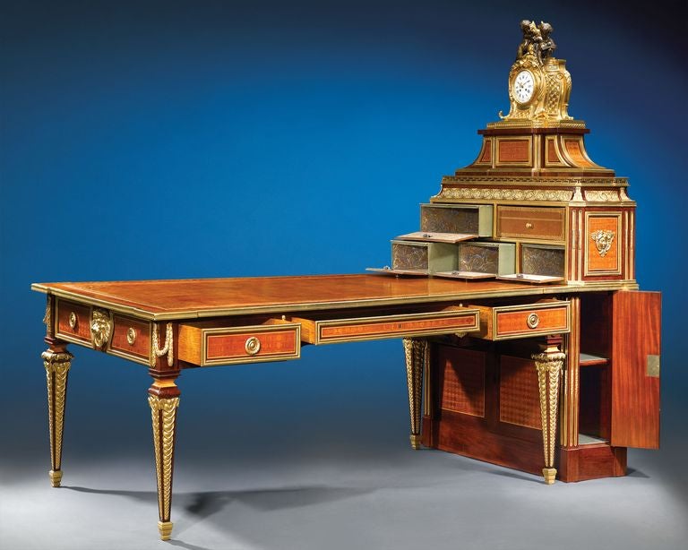 The grandness and luxury of French design culminate in this partner's desk and multiple-drawer cartonnier, crafted by master cabinetmaker Paul Sormani. Sormani created this exceptional work after the model by Simon Oeben, one of the most successful