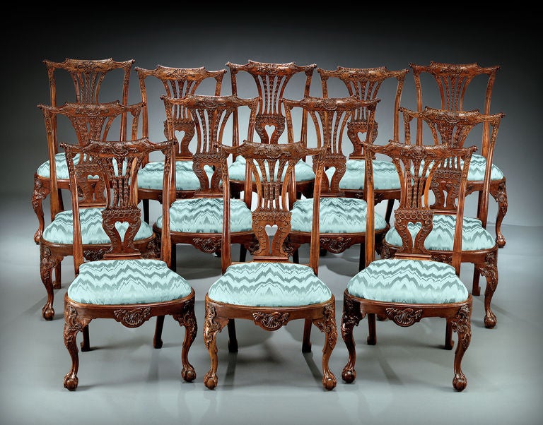 An extremely rare and important set of 12 Chippendale period walnut dining chairs of the absolute highest order. Boasting elements of both English and Continental design, these luxuriously carved chairs are indicative of classic Chippendale.