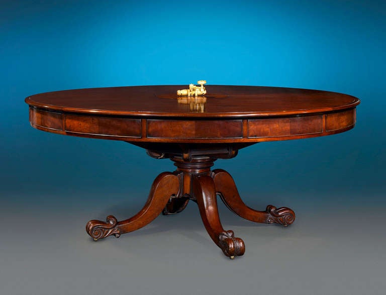 A work of extraordinary beauty and rarity, this magnificent Irish mechanical dining table transforms into a stunning games table with just a few turns. Crafted of impeccable Cuban mahogany, this table exhibits a striking patina and a beautifully