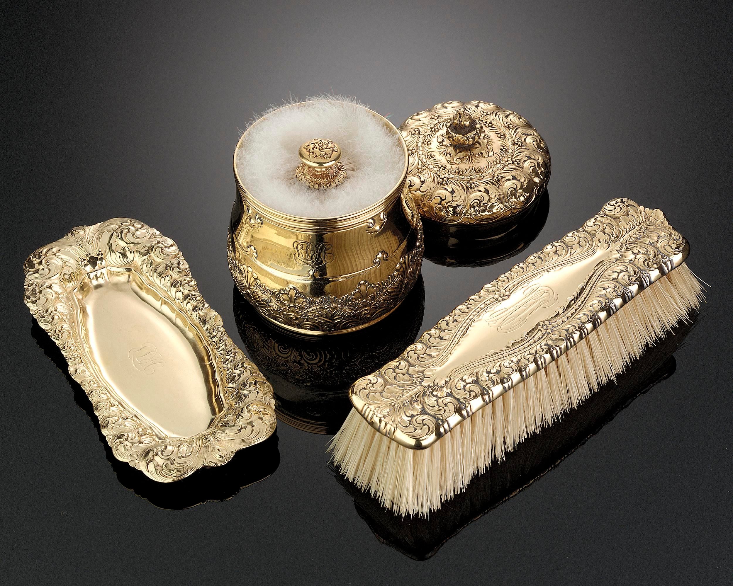 A lovely Tiffany silver gilt dresser set complete with a brush, powder jar and tray wonderfully decorated with elaborate foliate borders. Date marked 1891-1902. Tiffany Silver. Excellent condition.
Measures:
Brush: 2” wide x 7” long.
Powder: 3”