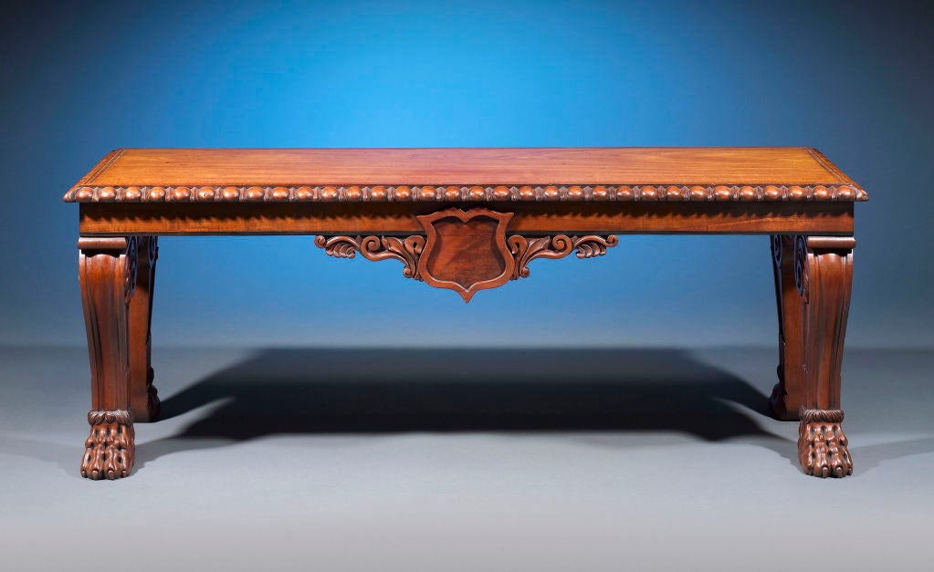Classical Georgian features such as gadrooned edging and cabriole legs ending in intricately carved claw feet distinguish this handsome mahogany bench. The richness of the wood and the extreme attention given to the carving of this bench make it a