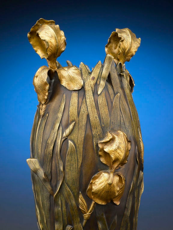A field of lifelike irises dominates this rare and enchanting pair of antique bronze Art Nouveau vases. Monumental in size and craftsmanship, the vases display a repoussé motif of irises and their slender leaves in high relief. Depth and dimension