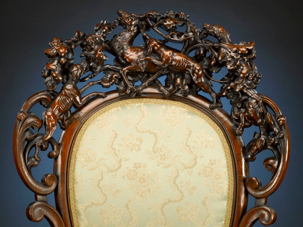 A ferocious hunting scene is the focus of this extraordinary carved chair by inimitable ébéniste Alexander Roux. Crafted in the exuberant Rococo style, this chair exhibits carving of the highest order, from the stunning openwork scene of hunting