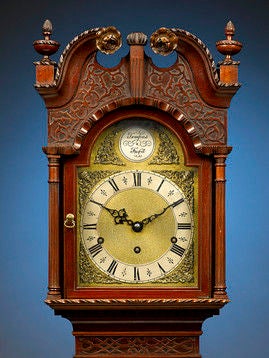 This slender and dignified mahogany grandmother clock has an understated charm. Crafted of luxurious Cuban mahogany, this extremely rare clock is perfectly proportioned, with classical architectural features and exceptional carving. A single