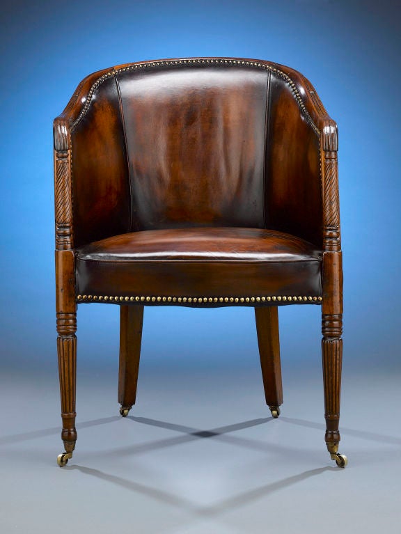 This attractive Regency-period desk, or library chair, is a fine example of early 19th-century furniture making. The chair is expertly hand-crafted of rich mahogany, with the anterior uprights featuring classic Regency element of finely-spaced