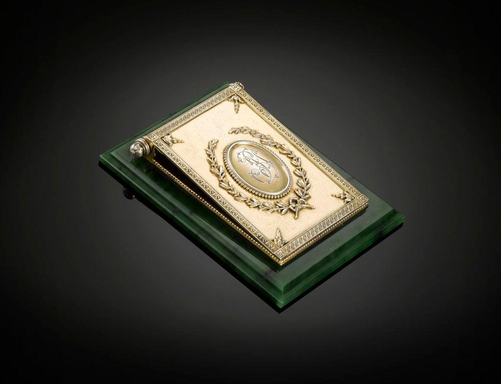 The magnificence and superior craftsmanship synonymous with the House of Fabergé is eloquently illustrated in this rare nephrite jade and silver gilt note holder. The polished nephrite base serves as the support for the masterfully executed silver