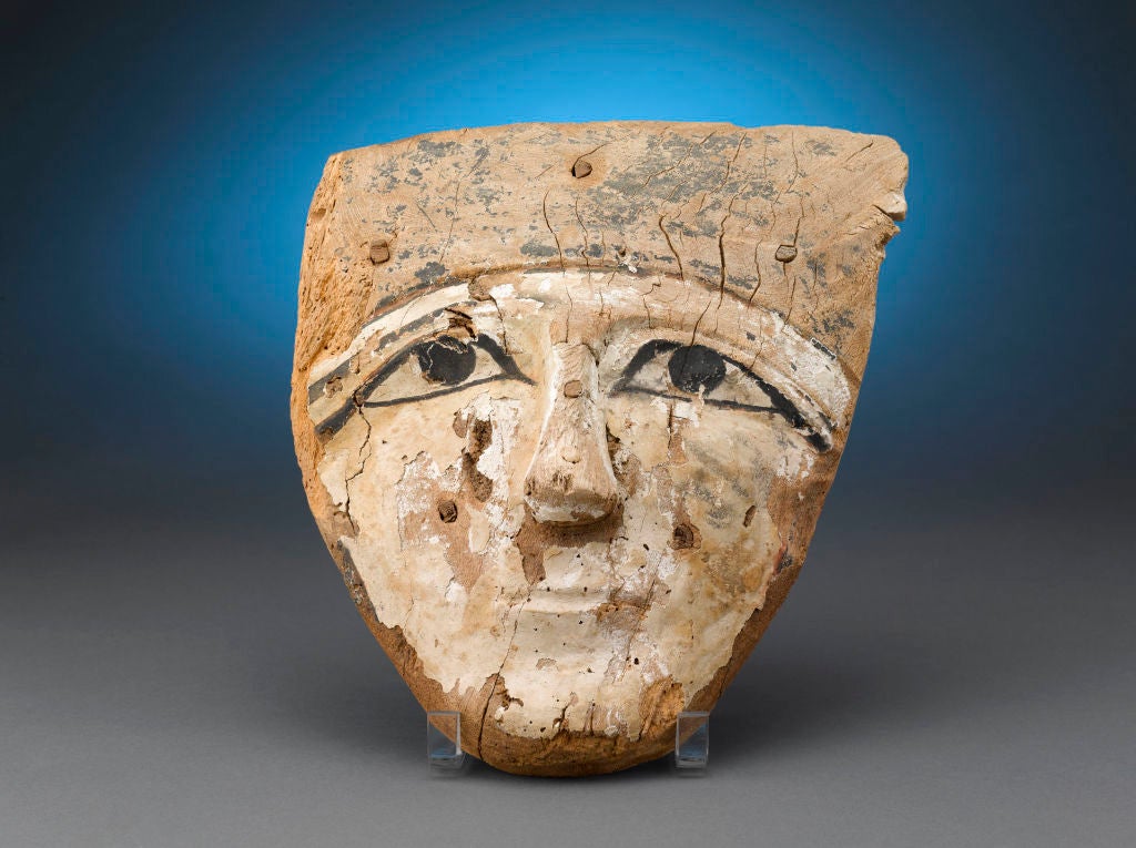 This amazing wooden sarcophagus mask is a stunning relic from Ancient Egypt. Originally part of a sarcophagus that was meant to forever protect the mummy of the deceased, this enigmatic face hails from the 26th Dynasty of the Late Kingdom. It is