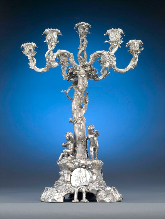 A glorious Victorian sterling silver five-light centerpiece majestically crafted with scrolling branches upon a base adorned with figures, rocks and fountains. Hallmarked by London silversmith Benjamin Stephens, this centerpiece is engraved with the