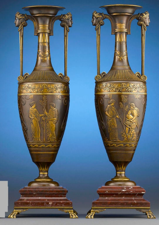 This striking pair of French bronze urns was designed in the fashionable néo-grec, or classical revival style by the Parisian sculptor Henry Cahieux and cast by famed founder Ferdinand Barbedienne. Barbedienne exhibited the model for these vases at