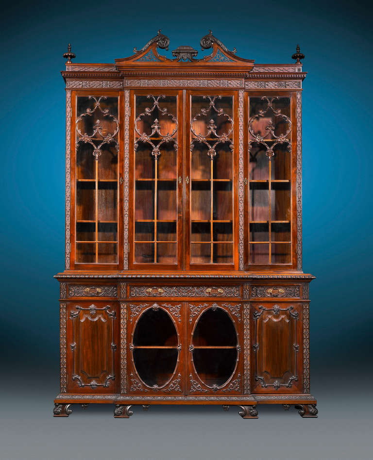 This beautiful Victorian library breakfront is crafted of Cuban mahogany in the majestic Chippendale Revival style. Standing at nine-feet high and displays all of the aesthetic hallmarks of Thomas Chippendale's iconic designs. Balanced and justly