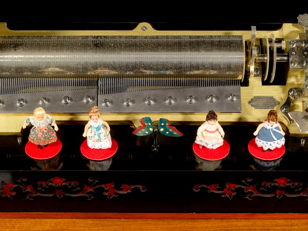 This exceptionally wonderful and quite rare antique musical automation box by the Mermod Frerès firm of Sainte-Croix, Switzerland is a marvel of music box craftsmanship. Though the window, the viewer can see a fluttering butterfly and four maidens