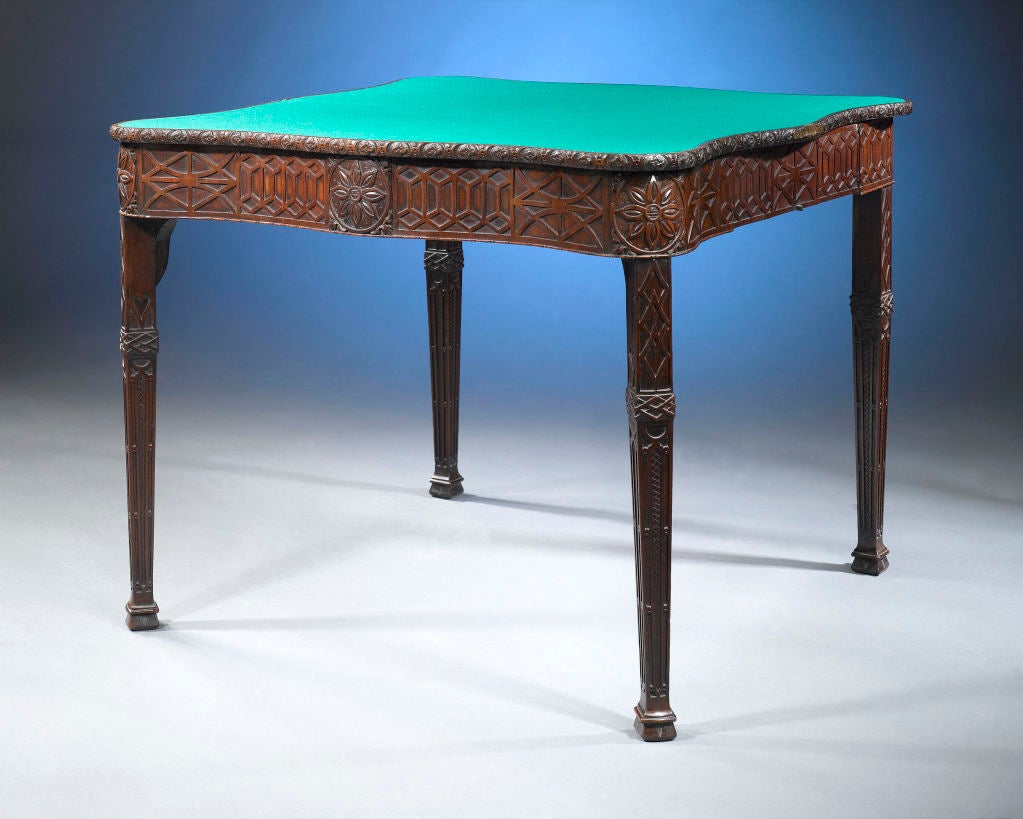 This phenomenal Georgian concertina card table is a masterpiece of English woodworking. Constructed for multifunctional use, this mahogany table displays beautifully integrated design elements in every position. Gothic architectural elements are