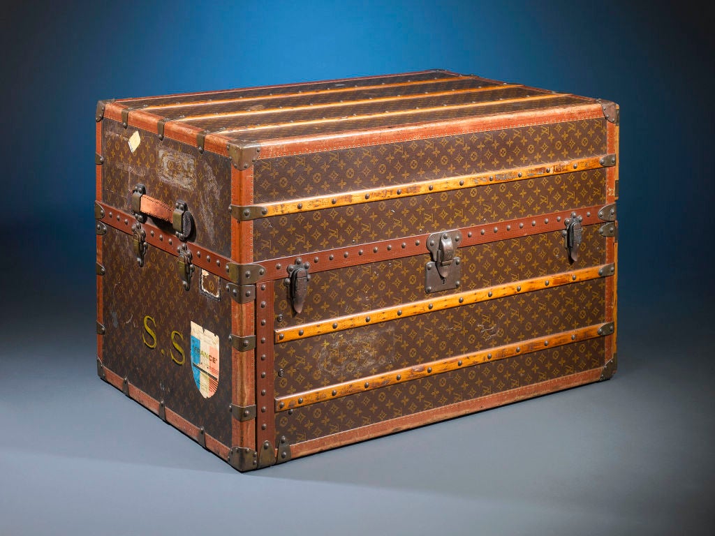 This rare and captivating vintage Louis Vuitton wardrobe trunk embodies the elegance and sophistication of a bygone era. Boasting the iconic “LV” monogram on its canvas-upholstered frame, this trunk is fully outfitted to facilitate the most
