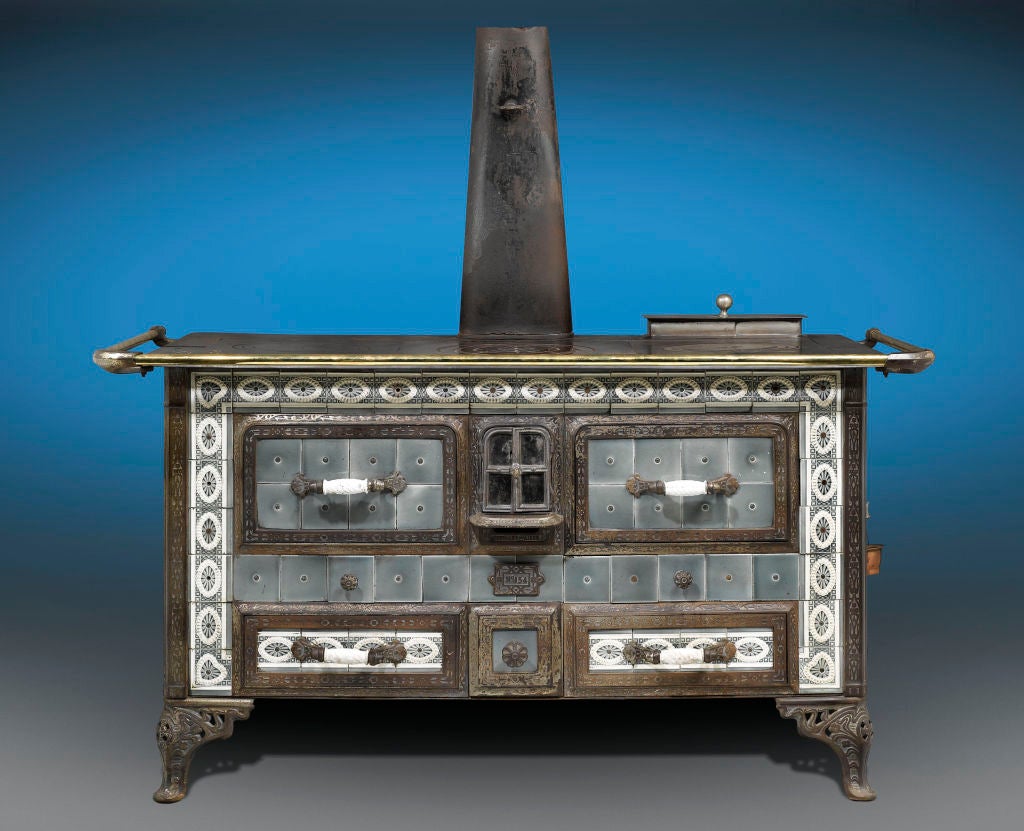 This extremely rare and striking Sougland-Aisne stored heat cooker is a work of outstanding design. This Art Nouveau-period cast iron stove could either be fired with charcoal or wood, and has three 