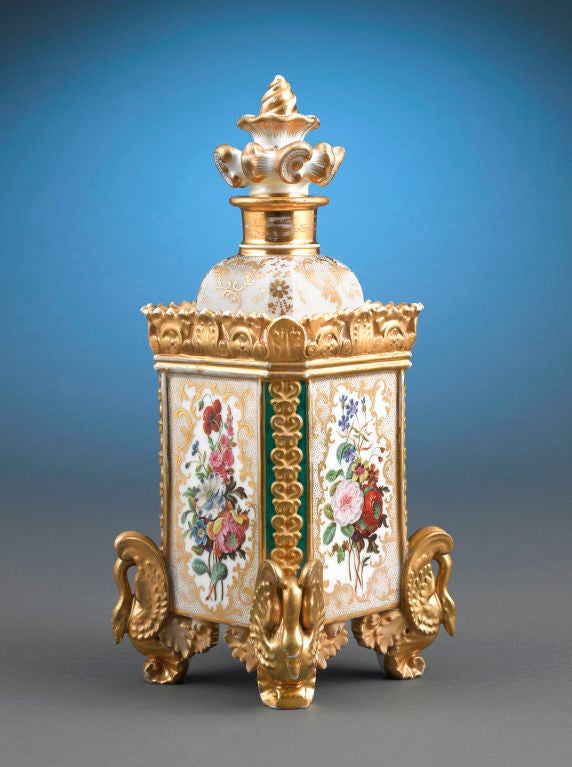 This charming and rare porcelain perfume bottle by Jacob Petit is a work of delicate beauty. Crafted in a rare square form, this intricate bottle is decorated with four panels of hand-painted flowers, each completely different, and sits upon four