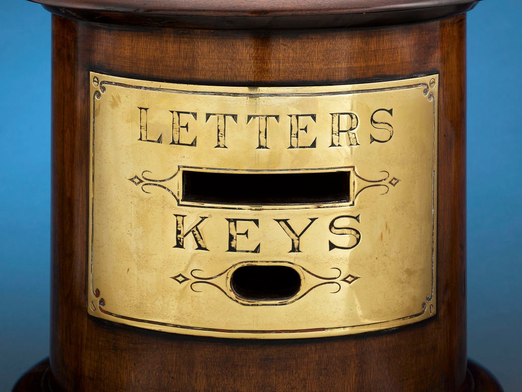 This intriguing letterbox and key drop would have been a staple in the finest hotels in the 19th and early 20th centuries. Crafted of beautifully polished mahogany, this cylindrical box features a brass label with two slots, one for letters and a