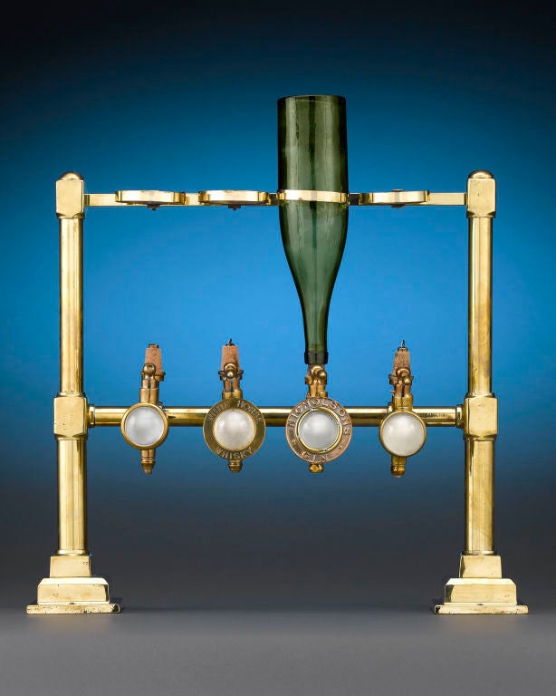 This set of four non-drip drink dispenser measures, also known as optics due to their resemblance to optical lenses, was a must-have for any professional bar. Crafted by Gaskell & Chambers of Birmingham, England, these gravity-fed dispensers took